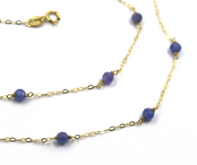 Cargar imagen en el visor de la galería, Collar rolo ovalado de 18" en oro amarillo de 18 quilates alternado con tanzanita azul facetada de 3 mm.