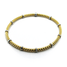Load image into Gallery viewer, 18k yellow white gold elastic bracelet, 3mm basket popcorn tube, worked discs.