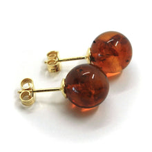 Load image into Gallery viewer, solid 18k yellow gold lobe earrings, orange amber 11mm spheres butterfly closure.