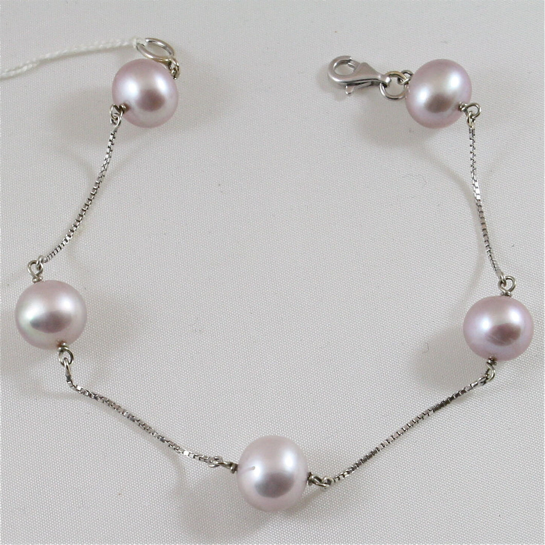 18k white gold with purple pearls (10-11 mm diam.) bracelet.