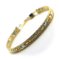 18K YELLOW WHITE ROSE GOLD BRACELET, SEMIRIGID, FINELY WORKED, FACETED TUBES.