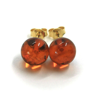 solid 18k yellow gold lobe earrings, orange amber 10mm spheres butterfly closure.