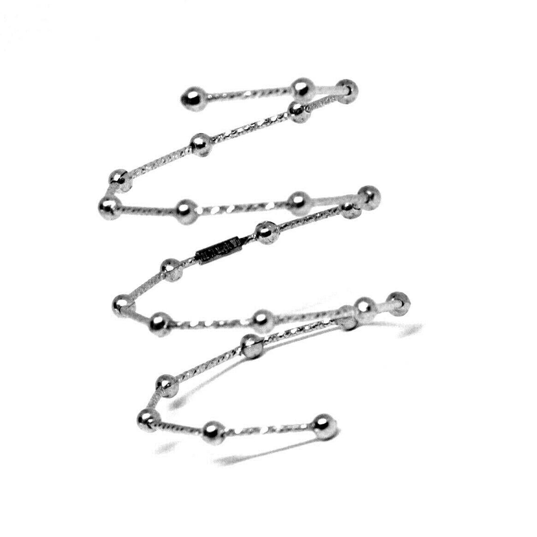 18k white gold Magicwire long finger ring, elastic worked wire, spheres, snake.