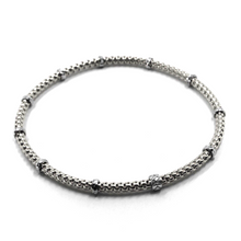 Load image into Gallery viewer, 18k white gold elastic bracelet, alternate 3mm basket popcorn tube, worked discs.
