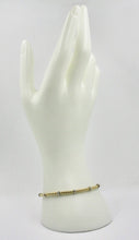 Load image into Gallery viewer, 18k yellow white gold elastic bracelet, 3mm basket popcorn tube, worked discs.
