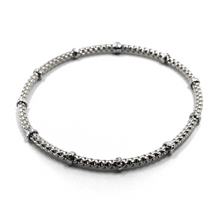 Load image into Gallery viewer, 18k white gold elastic bracelet, alternate 3mm basket popcorn tube, worked discs.
