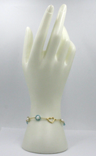 Load image into Gallery viewer, 18k yellow gold heart bracelet, green blue zirconia and freshwater pearls flower.
